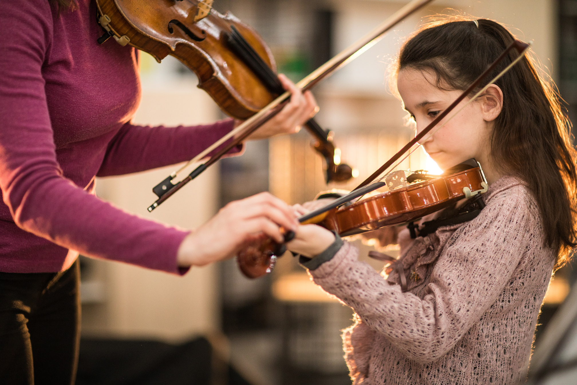 Teacher and student playing violin